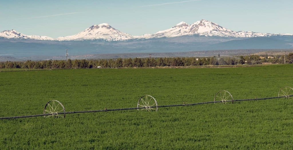 Farm irrigation tools stand in the farm fields near Three Sisters and Bend, Oregon